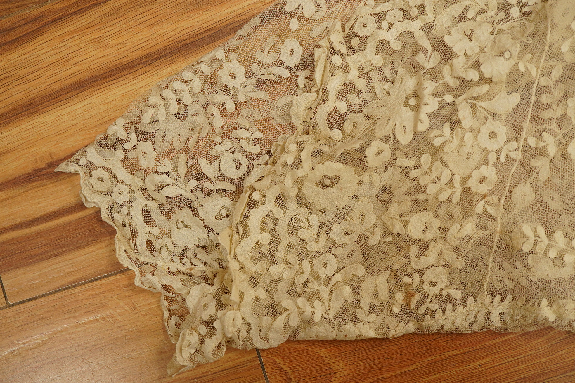 An Irish late 19th, Carrick Cross, Irish lace ladies shaped cape with collar, 200cm wide x 88cm long. Condition - a few dark rust stains and slight catches to net, but mainly in good condition.